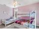 Bright bedroom with a bunk bed and twin bed, perfect for a growing Gathering at 8938 Cabot Cliffs Dr, Davenport, FL 33896
