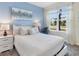 Cozy bedroom with a plush white bed, a stylish desk, and a large window with sheer curtains at 8938 Cabot Cliffs Dr, Davenport, FL 33896