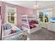 Charming bedroom with two beds, bright pink walls, and large windows bringing in natural light at 8938 Cabot Cliffs Dr, Davenport, FL 33896