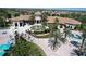 Exterior view of the community clubhouse, featuring lush landscaping, a fountain, and a welcoming entrance for gatherings and events at 8938 Cabot Cliffs Dr, Davenport, FL 33896