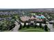 Aerial view of a beautiful community clubhouse with a resort style pool and lush landscaping at 8938 Cabot Cliffs Dr, Davenport, FL 33896