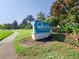 A community Clubhouse sign surrounded by lush tropical foliage on a bright sunny day at 8938 Cabot Cliffs Dr, Davenport, FL 33896