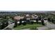 Aerial view of a beautiful community clubhouse with a resort style pool and ample parking at 8938 Cabot Cliffs Dr, Davenport, FL 33896