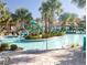 Gathering friendly community pool and splash pad with palm trees and plenty of seating at 8938 Cabot Cliffs Dr, Davenport, FL 33896