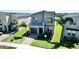 Modern two-story home with gray siding, well-manicured lawn, and paved walkway leading to the front entrance at 8938 Cabot Cliffs Dr, Davenport, FL 33896