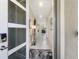 Inviting foyer with a decorative door and modern touches, leading into a brightly lit hallway at 8938 Cabot Cliffs Dr, Davenport, FL 33896