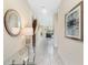 Elegant foyer featuring tile flooring, decorative table, and a staircase leading to the upper level at 8938 Cabot Cliffs Dr, Davenport, FL 33896