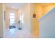 Bright foyer featuring marble tile flooring, modern lighting, and elegant decor at 8938 Cabot Cliffs Dr, Davenport, FL 33896