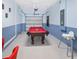 Spacious game room featuring a pool table, dart board, and painted block walls at 8938 Cabot Cliffs Dr, Davenport, FL 33896