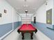 Garage features a pool table, painted walls, and a garage door; the walls are painted blue and white at 8938 Cabot Cliffs Dr, Davenport, FL 33896