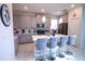 Well-appointed kitchen boasting a large island, pendant lights and seating for four on barstools at 8938 Cabot Cliffs Dr, Davenport, FL 33896