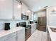 Modern kitchen with stainless steel appliances, white countertops, and gray cabinetry at 8938 Cabot Cliffs Dr, Davenport, FL 33896