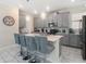 Contemporary kitchen featuring a large island, gray cabinets, and stylish pendant lighting at 8938 Cabot Cliffs Dr, Davenport, FL 33896