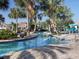 Relaxing lazy river pool with lounge chairs and palm trees, creating a resort-like setting at 8938 Cabot Cliffs Dr, Davenport, FL 33896