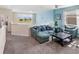 Inviting living room with plush seating, a ceiling fan, neutral carpeting, and views of the backyard at 8938 Cabot Cliffs Dr, Davenport, FL 33896