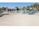Resort-style pool featuring a bar, plenty of lounge chairs, and beautiful palm trees for a relaxing vacation at 8938 Cabot Cliffs Dr, Davenport, FL 33896