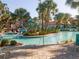 Beautiful zero-entry pool with a water slide, lush landscaping, and lounge chairs for relaxing poolside at 8938 Cabot Cliffs Dr, Davenport, FL 33896