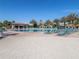 Resort-style pool featuring a bar, plenty of lounge chairs, and beautiful palm trees for a relaxing vacation at 8938 Cabot Cliffs Dr, Davenport, FL 33896