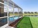Backyard view of a screened-in pool and patio area, perfect for enjoying the outdoor space at 8938 Cabot Cliffs Dr, Davenport, FL 33896