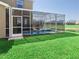 Backyard view of a screened-in pool area, ideal for outdoor enjoyment with a view of green space at 8938 Cabot Cliffs Dr, Davenport, FL 33896