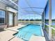 Enjoy the screened in pool with spa overlooking the beautiful pond and backyard at 8938 Cabot Cliffs Dr, Davenport, FL 33896