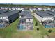 Aerial view of home featuring a screened-in pool, green lawn, and well-maintained landscaping at 8938 Cabot Cliffs Dr, Davenport, FL 33896