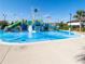 Colorful water splash pad surrounded by palm trees and clear blue skies at 8938 Cabot Cliffs Dr, Davenport, FL 33896