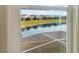 Beautiful backyard views from the window, featuring a tranquil lake and lush green space at 8938 Cabot Cliffs Dr, Davenport, FL 33896
