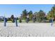 Sandy outdoor volleyball court on beautifully manicured grounds is ready for a pick-up game at 8938 Cabot Cliffs Dr, Davenport, FL 33896