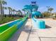 Colorful water slides on a bright sunny day with lush tropical landscaping surrounding the attraction at 8938 Cabot Cliffs Dr, Davenport, FL 33896