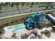 Aerial view of a community waterpark with twisting slides and a splash zone for residents at 8938 Cabot Cliffs Dr, Davenport, FL 33896