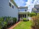 Serene backyard featuring a brick pathway leading to a covered porch, surrounded by lush landscaping at 2072 Hartz Aly, Orlando, FL 32814