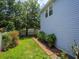Lush backyard with a brick pathway, manicured lawn, and mature trees along the property line at 2072 Hartz Aly, Orlando, FL 32814
