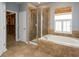 Bathroom features a soaking tub, glass-enclosed shower, and tile accents at 2072 Hartz Aly, Orlando, FL 32814
