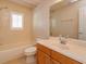 Bright bathroom featuring a tub-shower combination, neutral tile, and a wood vanity at 2072 Hartz Aly, Orlando, FL 32814