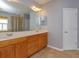 Bathroom with double sink vanity, framed mirrors, and separate bathtub and shower at 2072 Hartz Aly, Orlando, FL 32814
