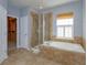 Bathroom boasting a soaking tub, a separate shower, and an attached closet at 2072 Hartz Aly, Orlando, FL 32814