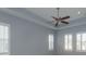 Bedroom boasts tray ceiling, fan, and ample natural light with white shutters at 2072 Hartz Aly, Orlando, FL 32814