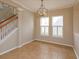 Bright dining area with tile flooring, a modern chandelier, and a staircase at 2072 Hartz Aly, Orlando, FL 32814