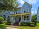 Charming two-story home featuring a covered porch with classic columns and landscaped front yard at 2072 Hartz Aly, Orlando, FL 32814