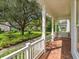 Charming porch view featuring lush landscaping and a swing, perfect for relaxing and enjoying the neighborhood at 2072 Hartz Aly, Orlando, FL 32814
