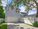 Exterior view of the two-story home features a detached garage and a well-maintained backyard at 2072 Hartz Aly, Orlando, FL 32814