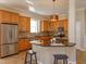 Open kitchen with granite countertops, wood cabinets, and stainless steel appliances at 2072 Hartz Aly, Orlando, FL 32814