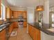 Stylish kitchen with granite countertops, wood cabinets, and stainless steel appliances at 2072 Hartz Aly, Orlando, FL 32814