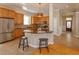 Open kitchen with granite countertops, wood cabinets, and stainless steel appliances at 2072 Hartz Aly, Orlando, FL 32814