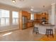 Open kitchen with stainless steel appliances, wood cabinets, and a breakfast bar at 2072 Hartz Aly, Orlando, FL 32814