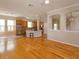 Open-concept living area flowing into the kitchen with hardwood floors at 2072 Hartz Aly, Orlando, FL 32814