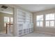Bright living room featuring built-in bookshelves, large windows, and plush carpeting at 2072 Hartz Aly, Orlando, FL 32814