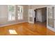 Well-lit living room featuring hardwood floors, large windows with shutters, and double doors to an adjacent room at 2072 Hartz Aly, Orlando, FL 32814