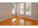 Bright room with hardwood floors and natural light from windows with white shutters at 2072 Hartz Aly, Orlando, FL 32814